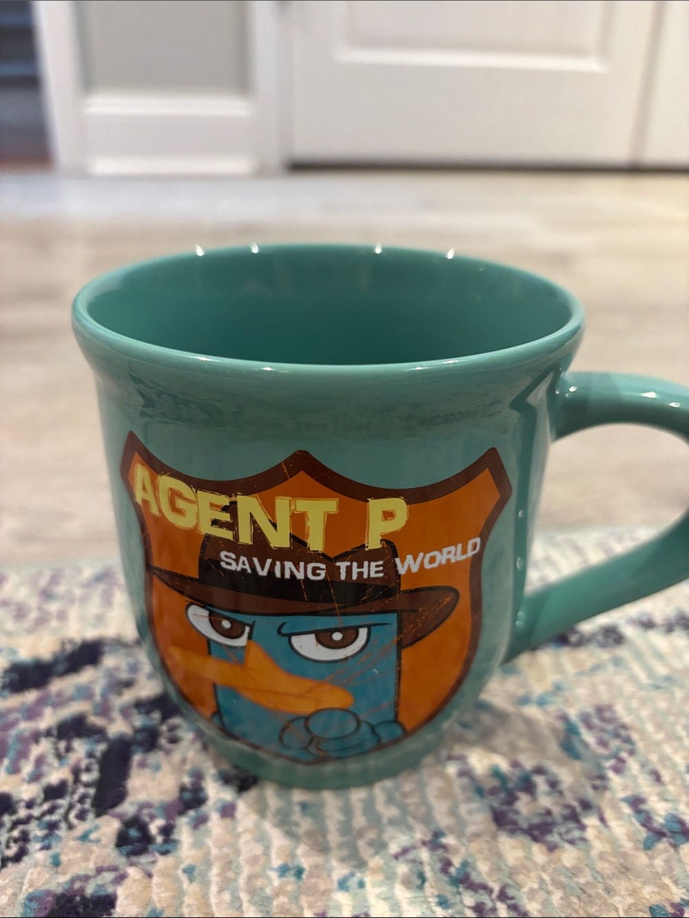 Disney Turquoise Agent P Ceramic Mug with Orange Shield Graphic
